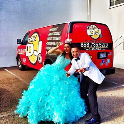 Quinceañera in a turquoise gown posing with the DJ beside the company van